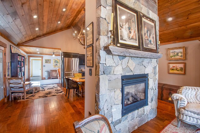 12 Charlies Way, Readfield, ME 04355 - living room featuring wooden ceiling, recessed lighting, a stone fireplace, and hardwood / wood-style floors
