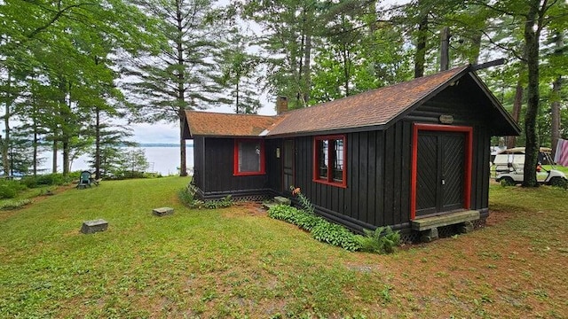 view of outbuilding featuring a water view