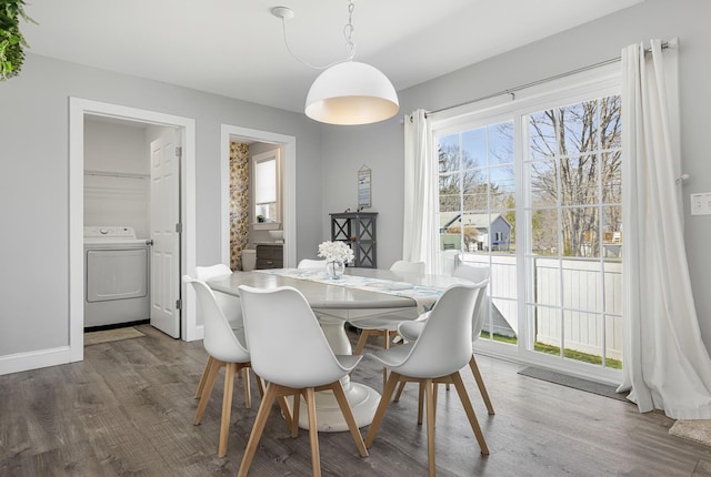dining area featuring washer / dryer, wood finished floors, and baseboards