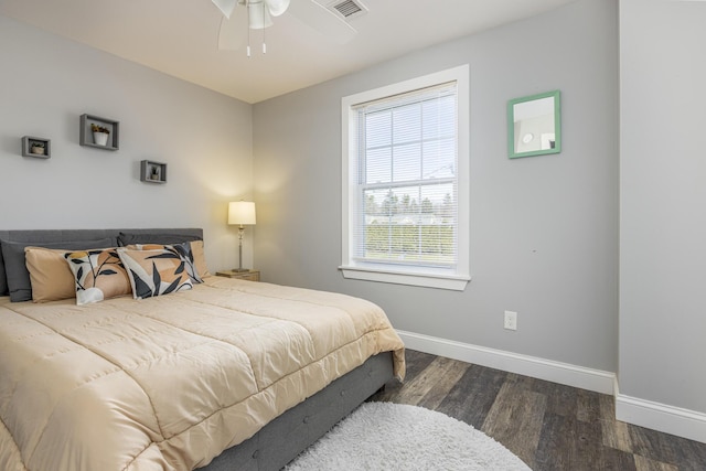 bedroom featuring wood finished floors, visible vents, baseboards, and ceiling fan