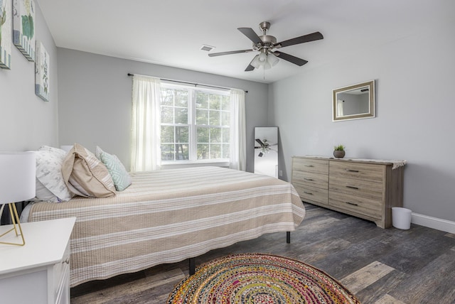bedroom with dark wood finished floors, baseboards, visible vents, and ceiling fan