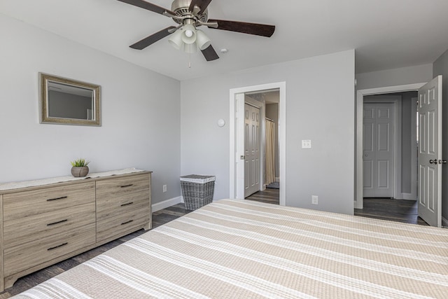 bedroom with ceiling fan, baseboards, and dark wood-style flooring