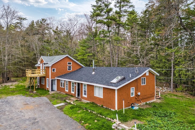285 Hockomock Rd, Woolwich, ME 04579 - view of front of house featuring a shingled roof, a wooden deck, stairs, and a wooded view