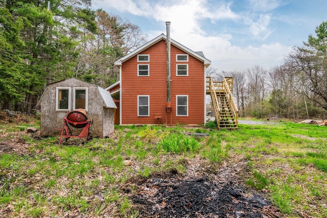 285 Hockomock Rd, Woolwich, ME 04579 - rear view of property featuring stairs, a deck, a storage unit, and an outbuilding