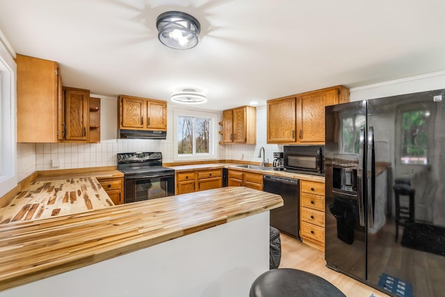 285 Hockomock Rd, Woolwich, ME 04579 - kitchen with black appliances, butcher block countertops, a sink, under cabinet range hood, and open shelves
