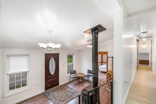 285 Hockomock Rd, Woolwich, ME 04579 - entrance foyer with wood finished floors, baseboards, a chandelier, and ornamental molding