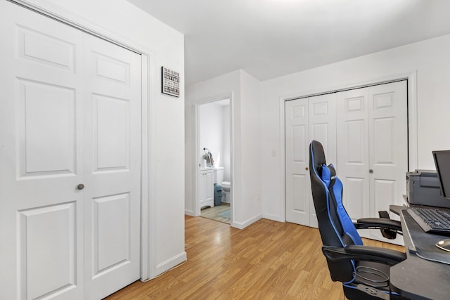 office area featuring baseboards and light wood-style floors