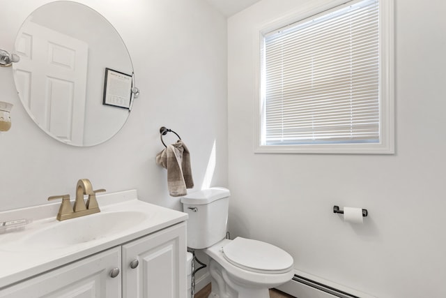 half bath with vanity, toilet, and a baseboard heating unit