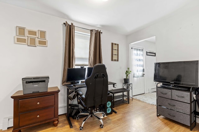 office with a baseboard radiator, wood finished floors, and baseboard heating