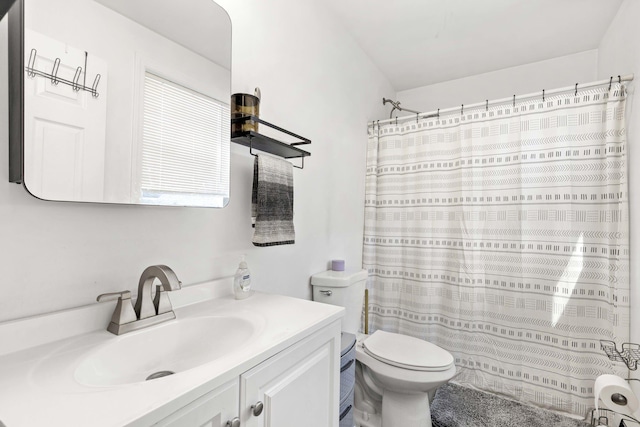 bathroom featuring vanity, toilet, and a shower with shower curtain