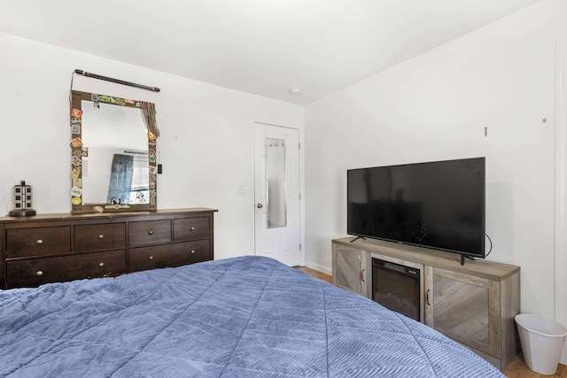bedroom with wood finished floors and baseboards