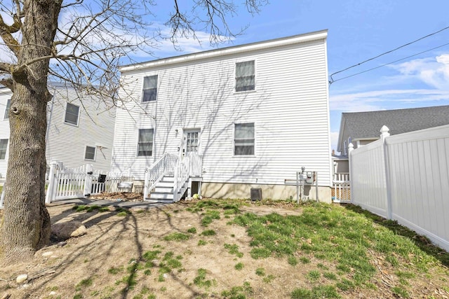 rear view of property with fence