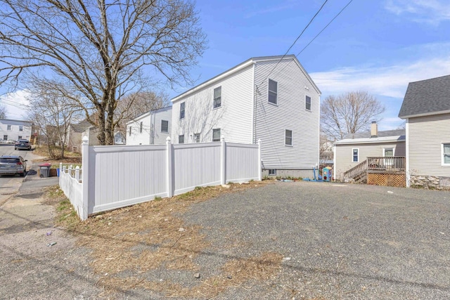 view of home's exterior with fence
