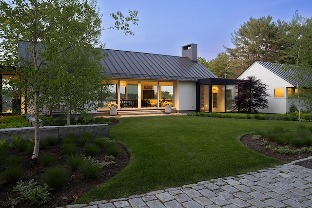 4 Ice House Pt, York, ME 03909 - rear view of house featuring a standing seam roof, a chimney, metal roof, and a yard