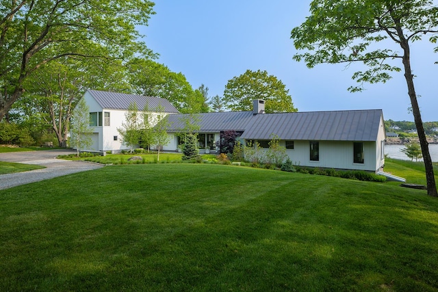 4 Ice House Pt, York, ME 03909 - view of front of house featuring driveway, a chimney, metal roof, and a front lawn
