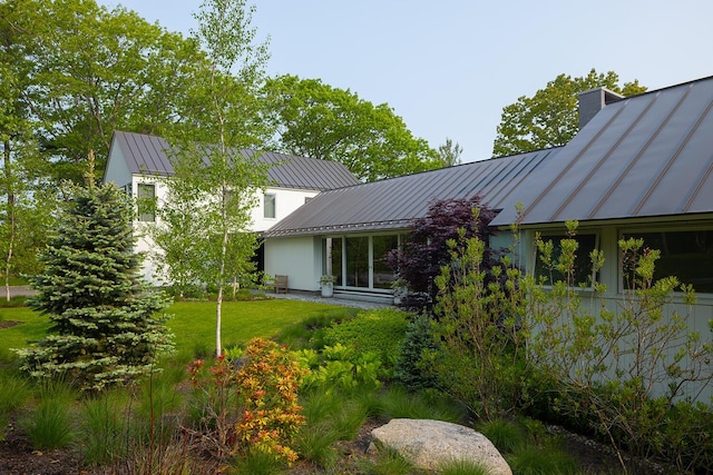 4 Ice House Pt, York, ME 03909 - rear view of house with a standing seam roof, metal roof, a yard, and a chimney