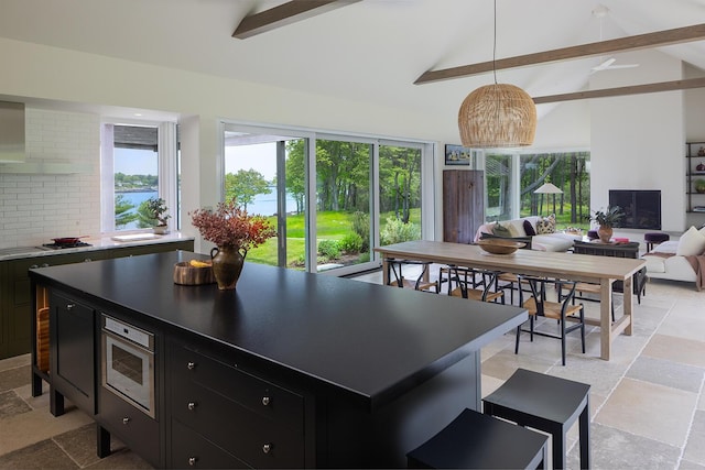 4 Ice House Pt, York, ME 03909 - kitchen featuring dark cabinetry, beam ceiling, stone tile flooring, plenty of natural light, and high vaulted ceiling