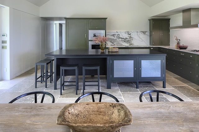 4 Ice House Pt, York, ME 03909 - kitchen featuring lofted ceiling, wall chimney exhaust hood, green cabinetry, a sink, and backsplash