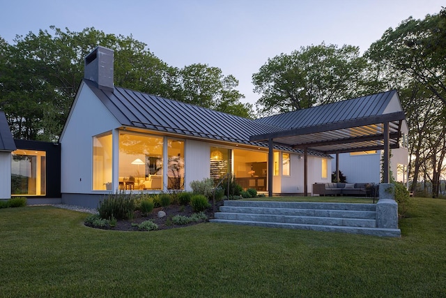 4 Ice House Pt, York, ME 03909 - back of house with a standing seam roof, an outdoor hangout area, metal roof, and a yard