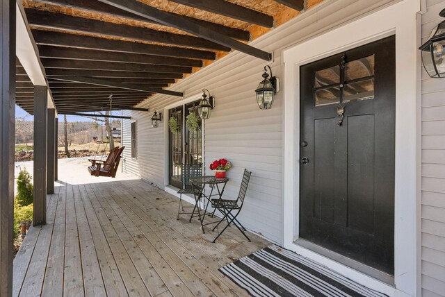 deck with a porch and a mountain view