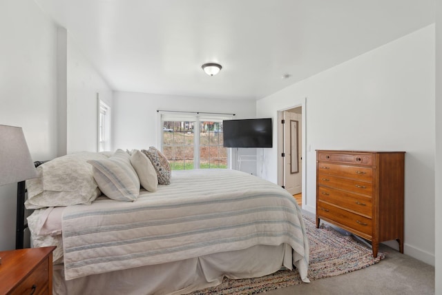 bedroom featuring baseboards and light carpet