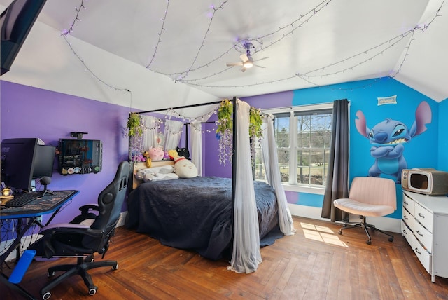bedroom featuring wood finished floors and lofted ceiling
