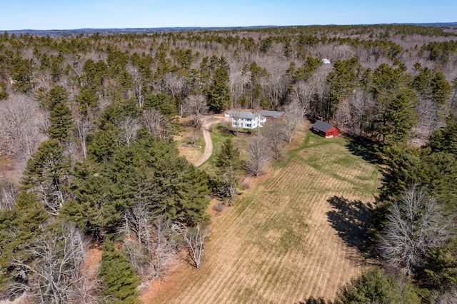 birds eye view of property featuring a rural view and a wooded view