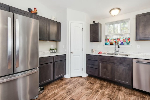 80 Dixon Rd, Lebanon, ME 04027 - kitchen featuring dark brown cabinetry, light countertops, appliances with stainless steel finishes, a sink, and wood finished floors