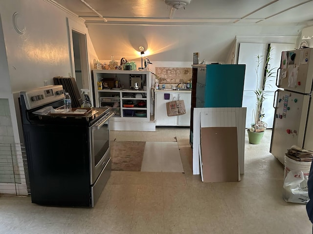kitchen featuring electric stove and freestanding refrigerator