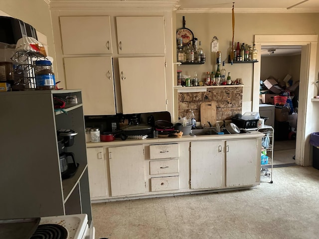 kitchen with ornamental molding and light countertops
