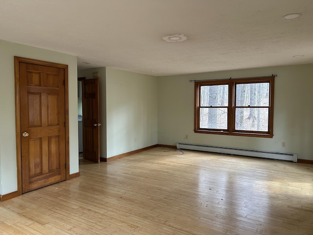 669 New Dam Rd, Waterboro, ME 04061 - unfurnished room featuring light wood-type flooring, a baseboard heating unit, and baseboards