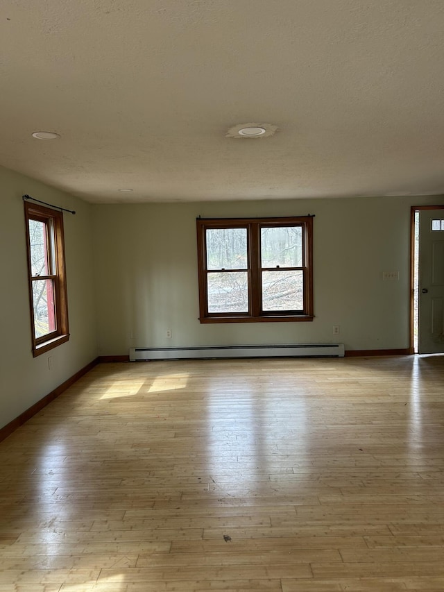 669 New Dam Rd, Waterboro, ME 04061 - spare room with a baseboard radiator, light wood finished floors, and baseboards