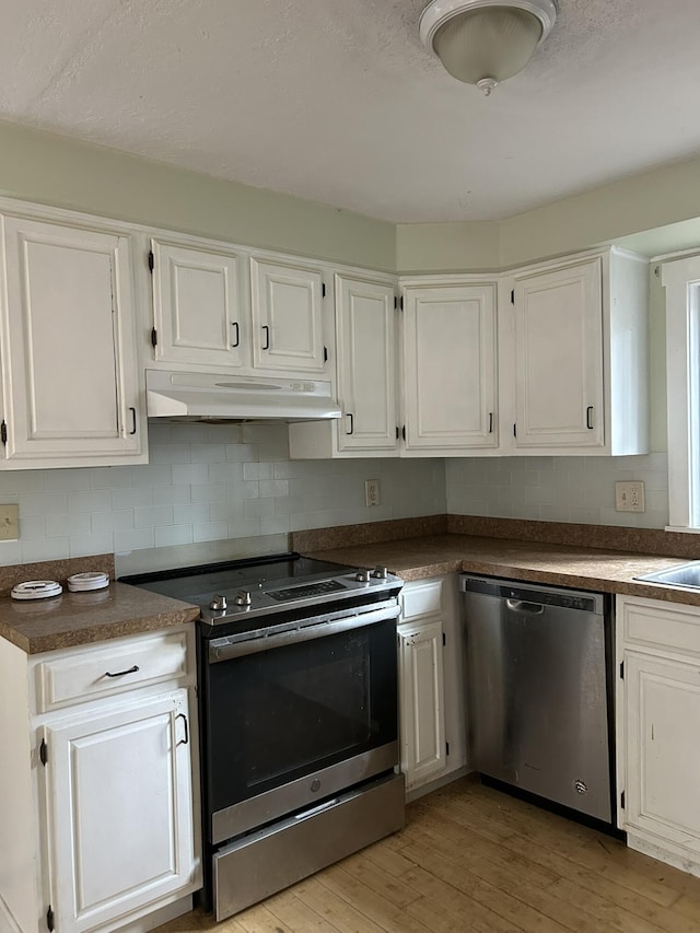669 New Dam Rd, Waterboro, ME 04061 - kitchen featuring stainless steel appliances, under cabinet range hood, white cabinets, and light wood-type flooring