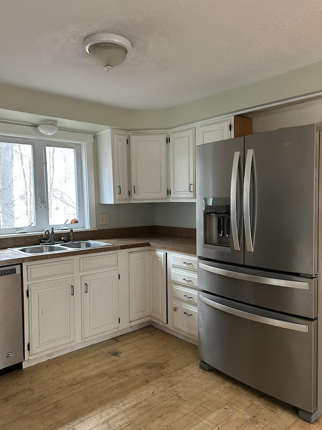 669 New Dam Rd, Waterboro, ME 04061 - kitchen featuring dark countertops, white cabinetry, a sink, and appliances with stainless steel finishes
