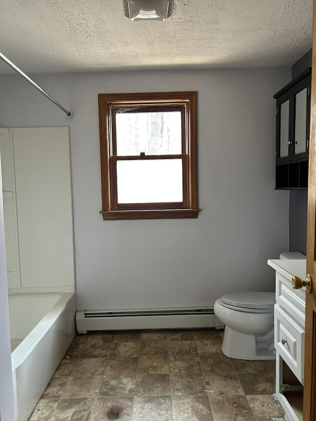 669 New Dam Rd, Waterboro, ME 04061 - bathroom with toilet, vanity, a baseboard heating unit, and stone finish flooring