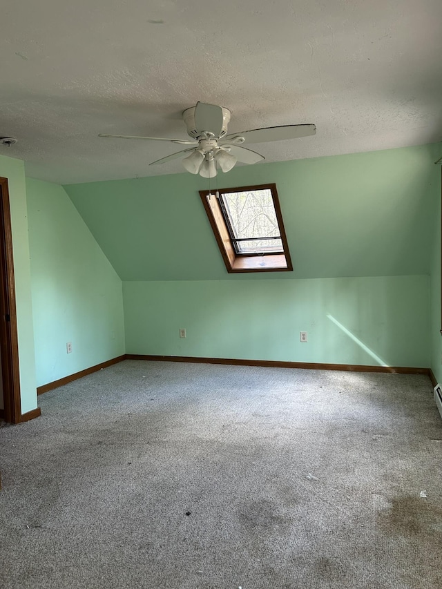 669 New Dam Rd, Waterboro, ME 04061 - bonus room with a textured ceiling, carpet flooring, a ceiling fan, and lofted ceiling with skylight