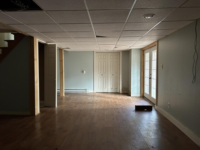 669 New Dam Rd, Waterboro, ME 04061 - interior space featuring baseboards, a paneled ceiling, baseboard heating, stairway, and wood finished floors