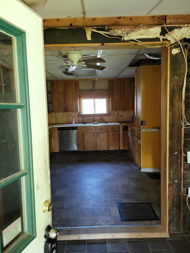 kitchen with dishwasher and brown cabinetry