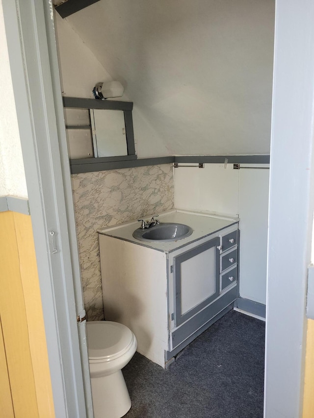 half bathroom featuring toilet and vanity