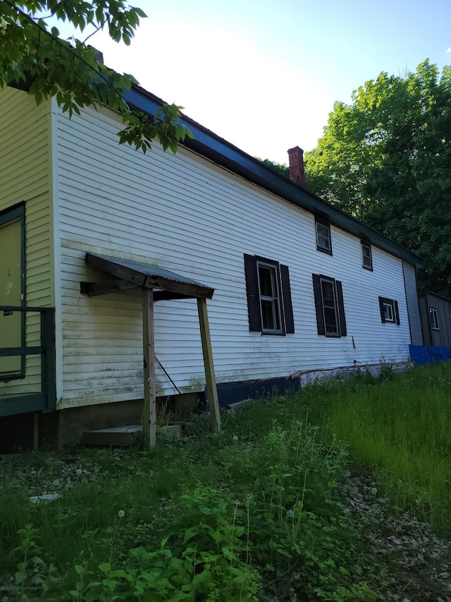 view of side of property featuring a chimney