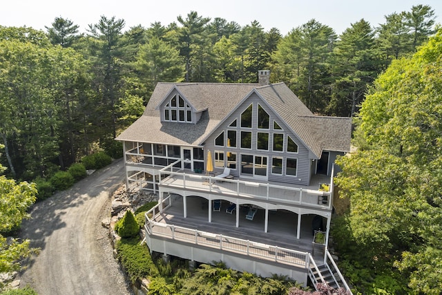 86 Firth Dr, Boothbay, ME 04537 - rear view of property with a forest view, a chimney, a wooden deck, and roof with shingles