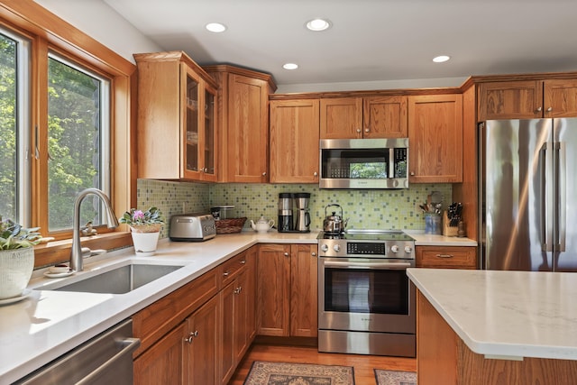 86 Firth Dr, Boothbay, ME 04537 - kitchen with appliances with stainless steel finishes, a sink, light countertops, brown cabinets, and recessed lighting