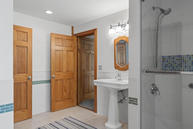 86 Firth Dr, Boothbay, ME 04537 - full bath with tile walls, a stall shower, tile patterned floors, wainscoting, and recessed lighting