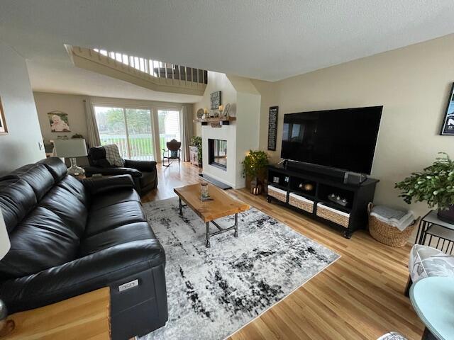 24 Clifford Rd Unit 18, Naples, ME 04055 - living room with a glass covered fireplace and wood finished floors