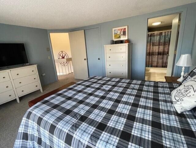 24 Clifford Rd Unit 18, Naples, ME 04055 - carpeted bedroom featuring connected bathroom, a textured ceiling, and a closet