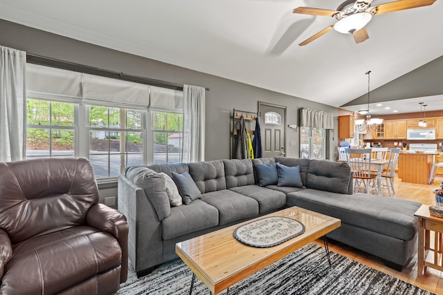 214 Gore Rd, Naples, ME 04055 - living area featuring a chandelier, light wood-style flooring, a ceiling fan, and lofted ceiling