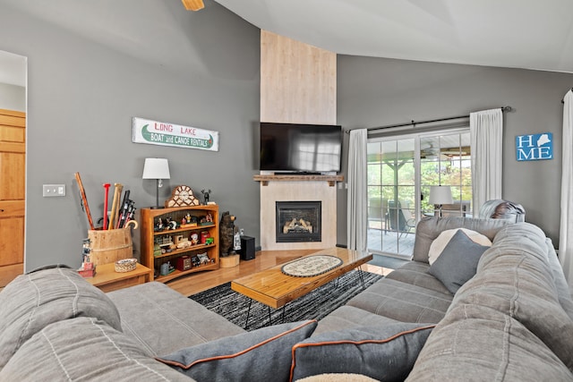 214 Gore Rd, Naples, ME 04055 - living room with high vaulted ceiling, a fireplace with raised hearth, and wood finished floors