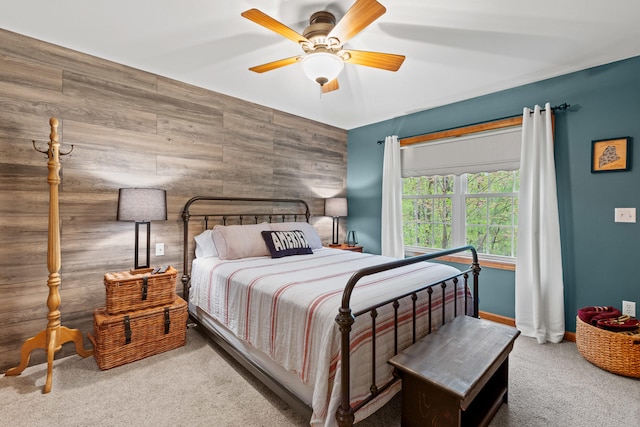 214 Gore Rd, Naples, ME 04055 - carpeted bedroom featuring wooden walls, an accent wall, ceiling fan, and baseboards