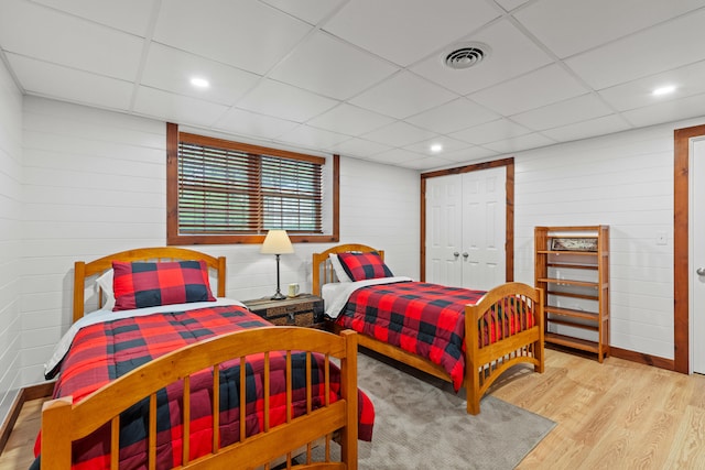 214 Gore Rd, Naples, ME 04055 - bedroom with wood finished floors, a paneled ceiling, a closet, and wood walls