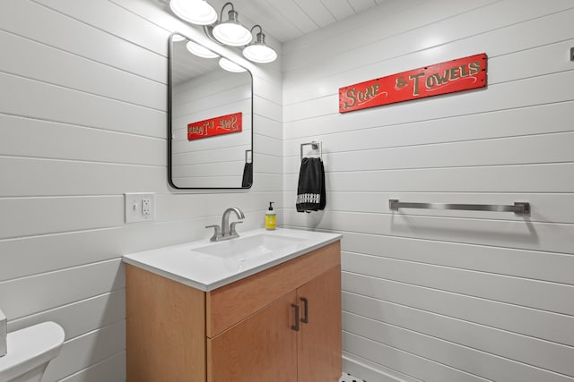 214 Gore Rd, Naples, ME 04055 - half bath featuring vanity, toilet, and wood walls